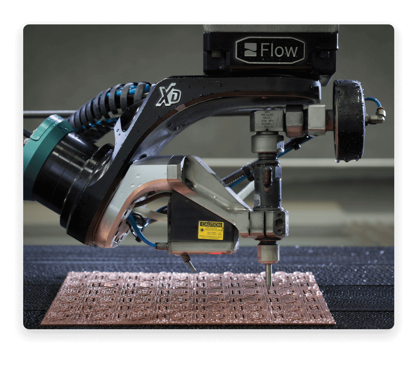 a waterjet cutting small precise cutouts in copper